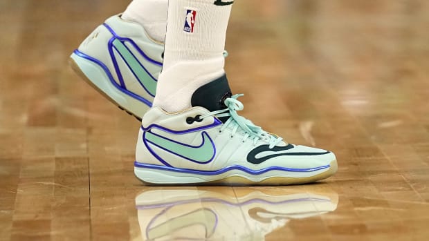 Milwaukee Bucks forward Khris Middleton's teal and black Nike sneakers.